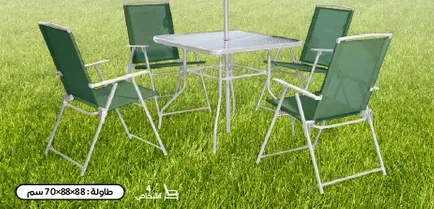 Table with four green chairs, suitable for outdoor use.