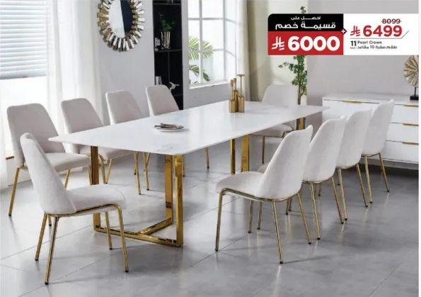 A modern dining table set with a white top and gold legs, accompanied by stylish chairs.