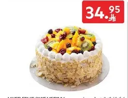 Mixed fruit cake with a variety of fruits on top.