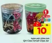 Assorted small claw clips in a jar.
